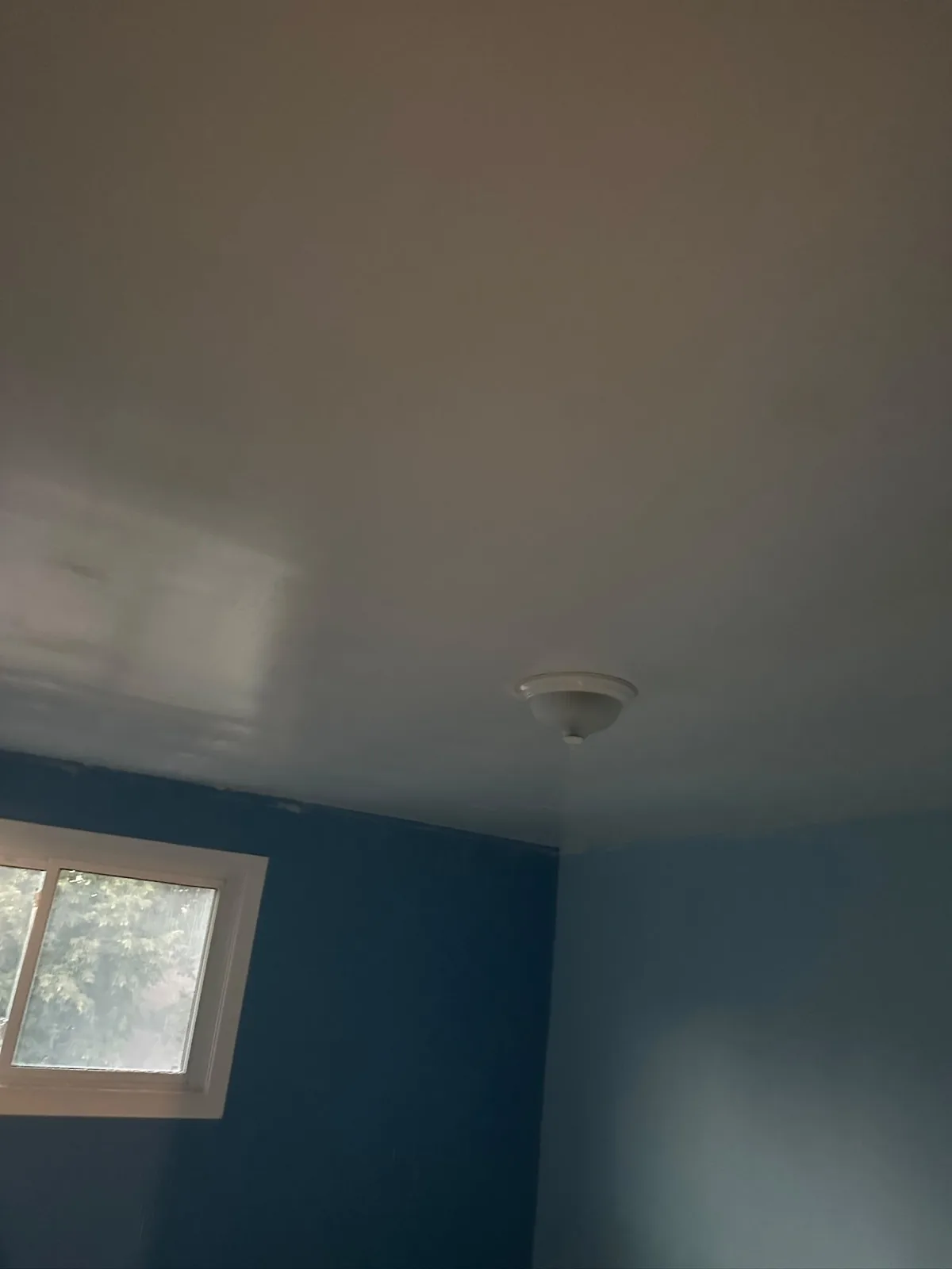 Residential ceiling after painting with a smooth renewed finish
