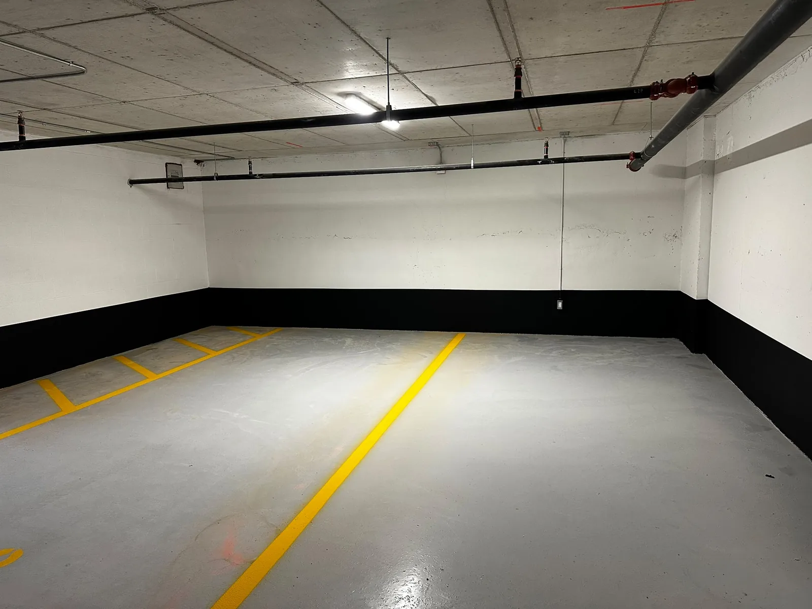 Cambridge commercial parking area after wall painting with black and white sections