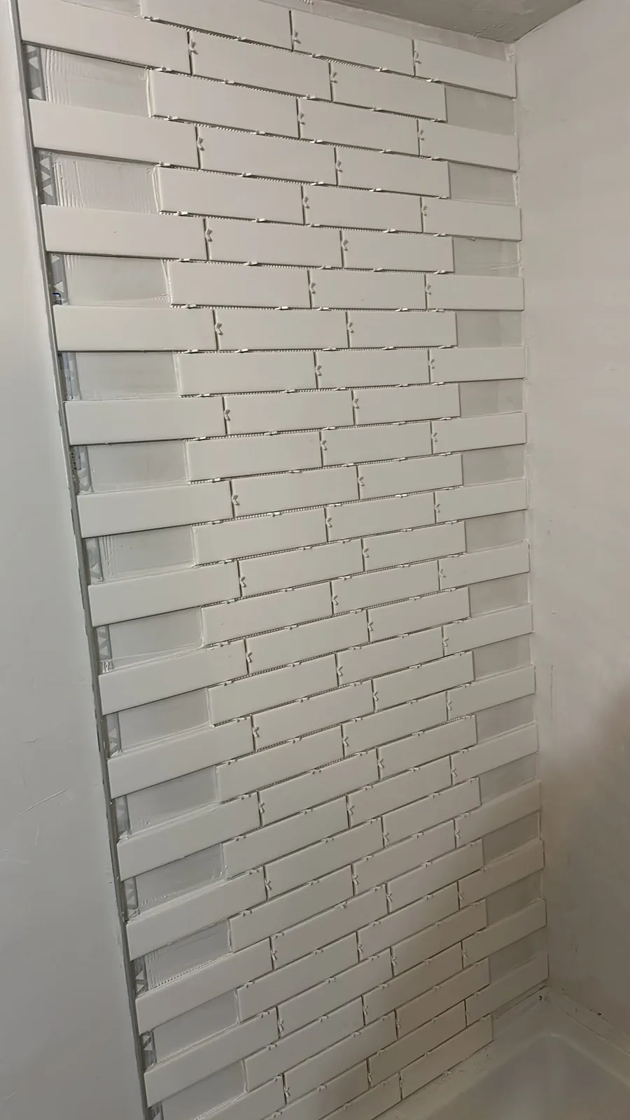 Kitchener bathroom tile installation in progress on a side wall