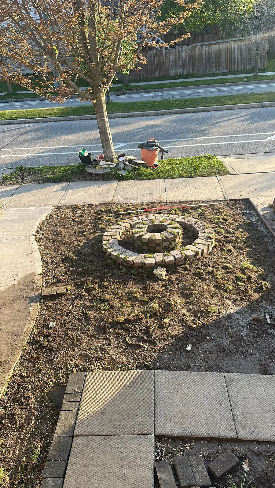 Waterloo front yard landscaping in progress with the lawn removed around a circular brick garden bed