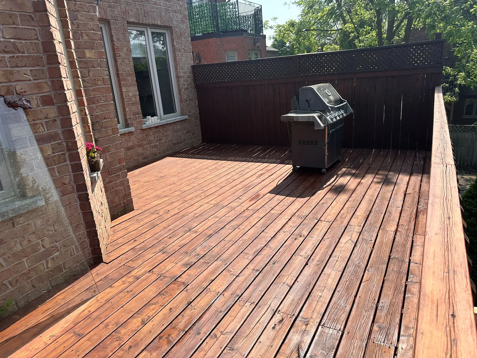 Wood deck after repair and painting with a renewed brown finish