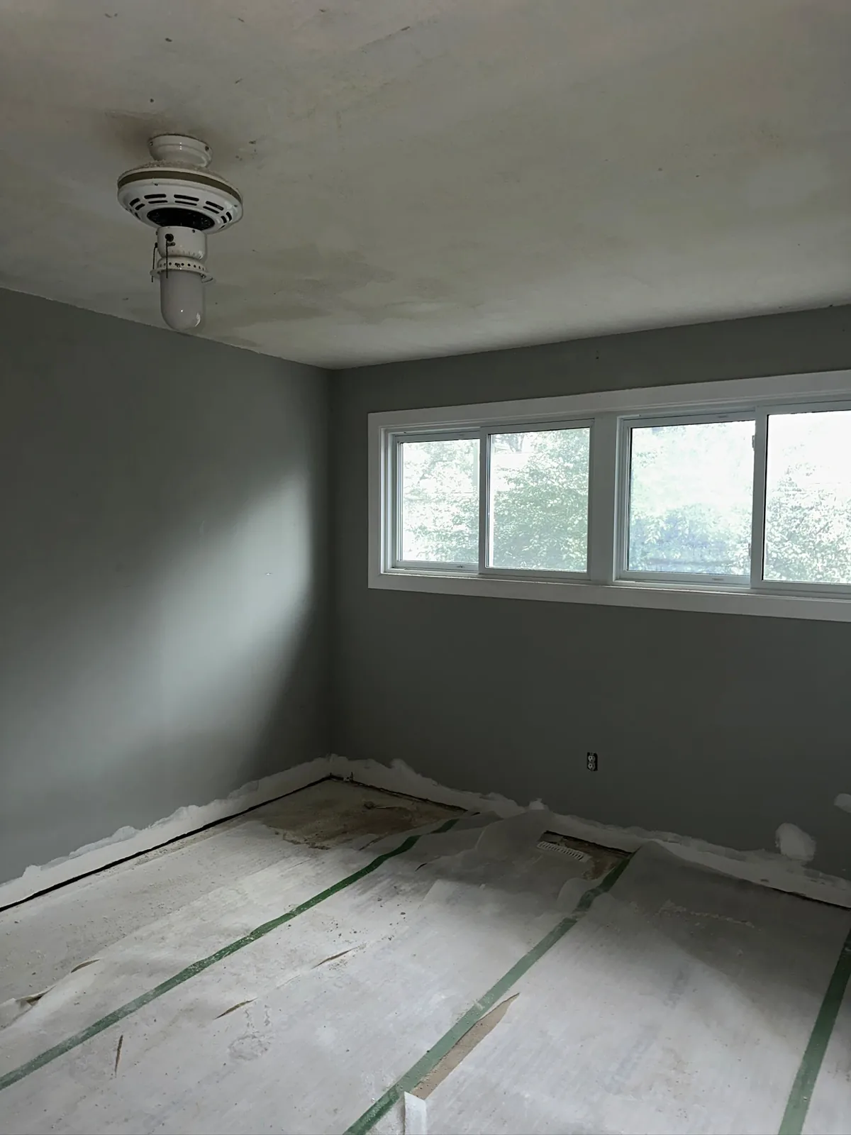 Residential interior painting project in Waterloo with grey walls and protected flooring