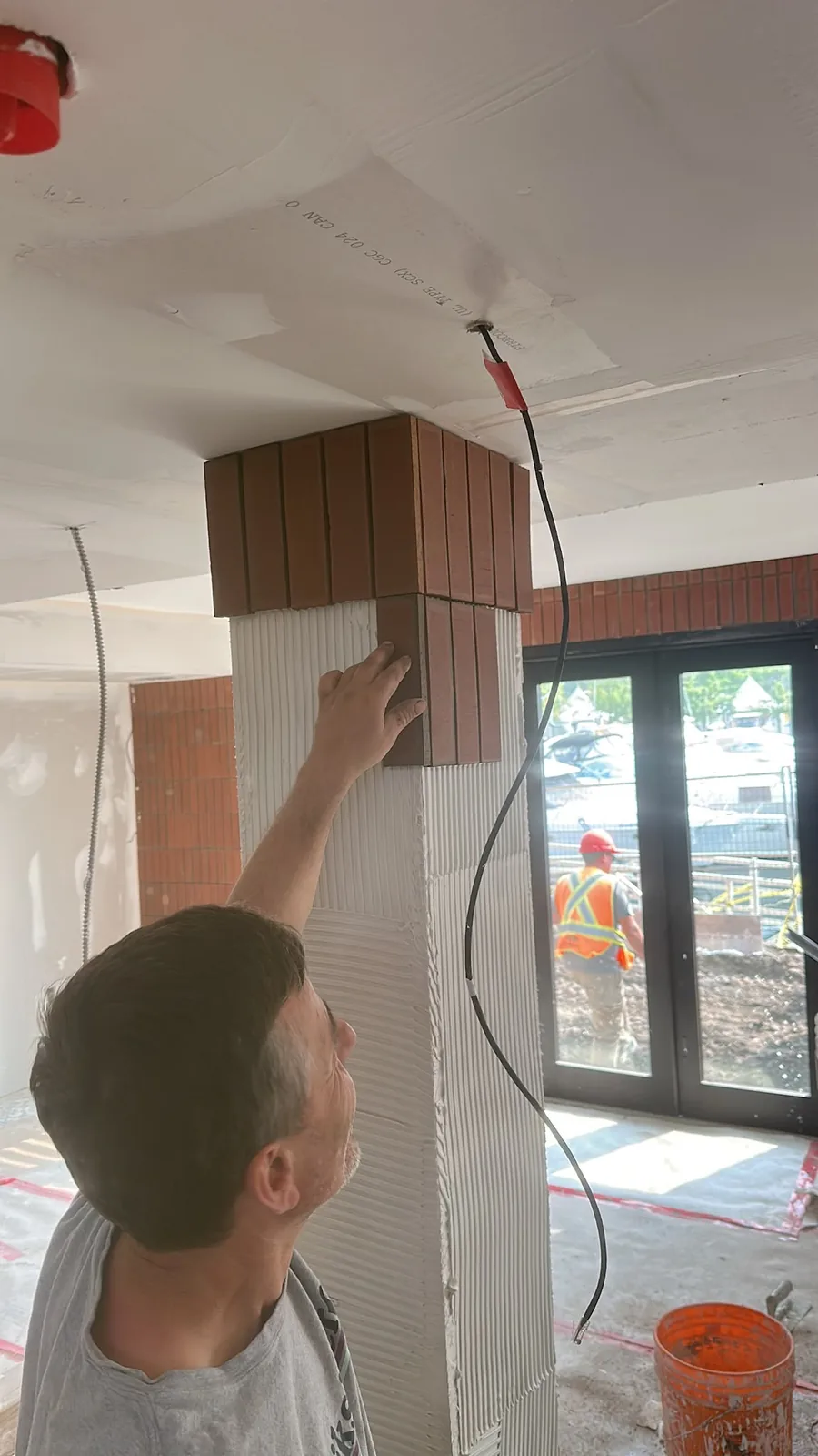 Commercial renovation work in progress with ceiling and column finishing
