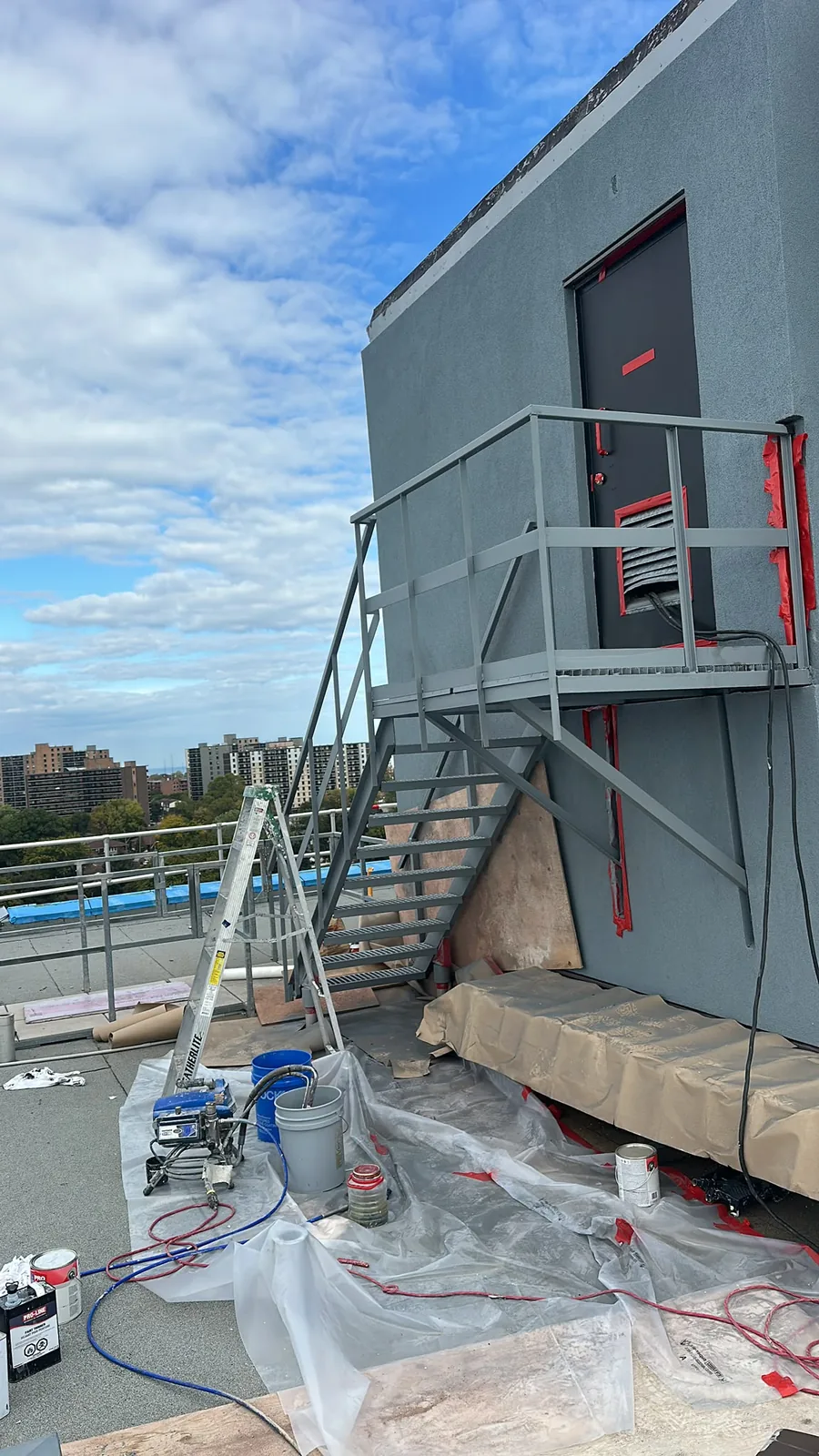 Exterior metal stairs and railings in Kitchener before repainting, with the work area prepared