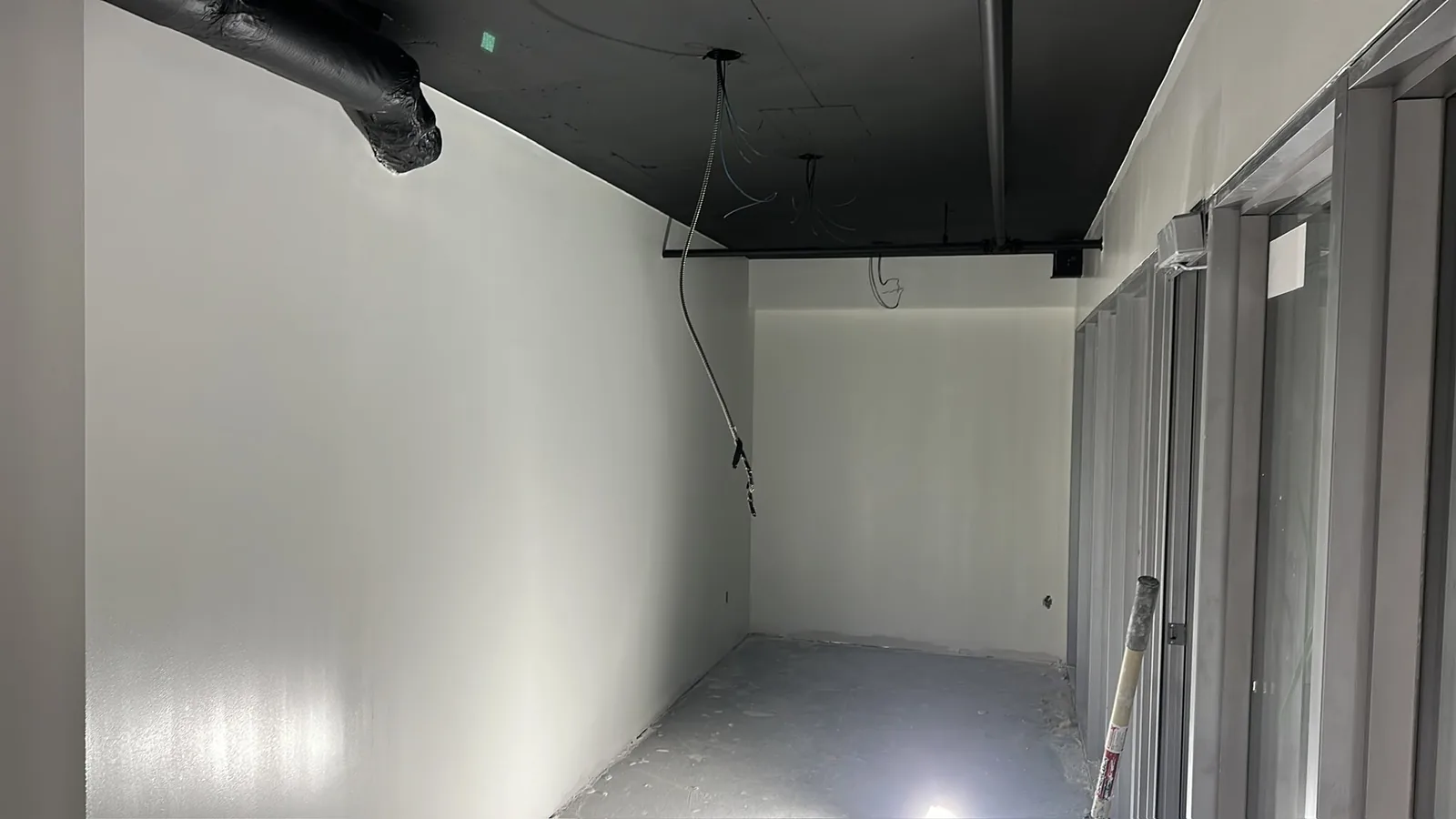 Commercial interior in Guelph with freshly painted white walls and black ceiling