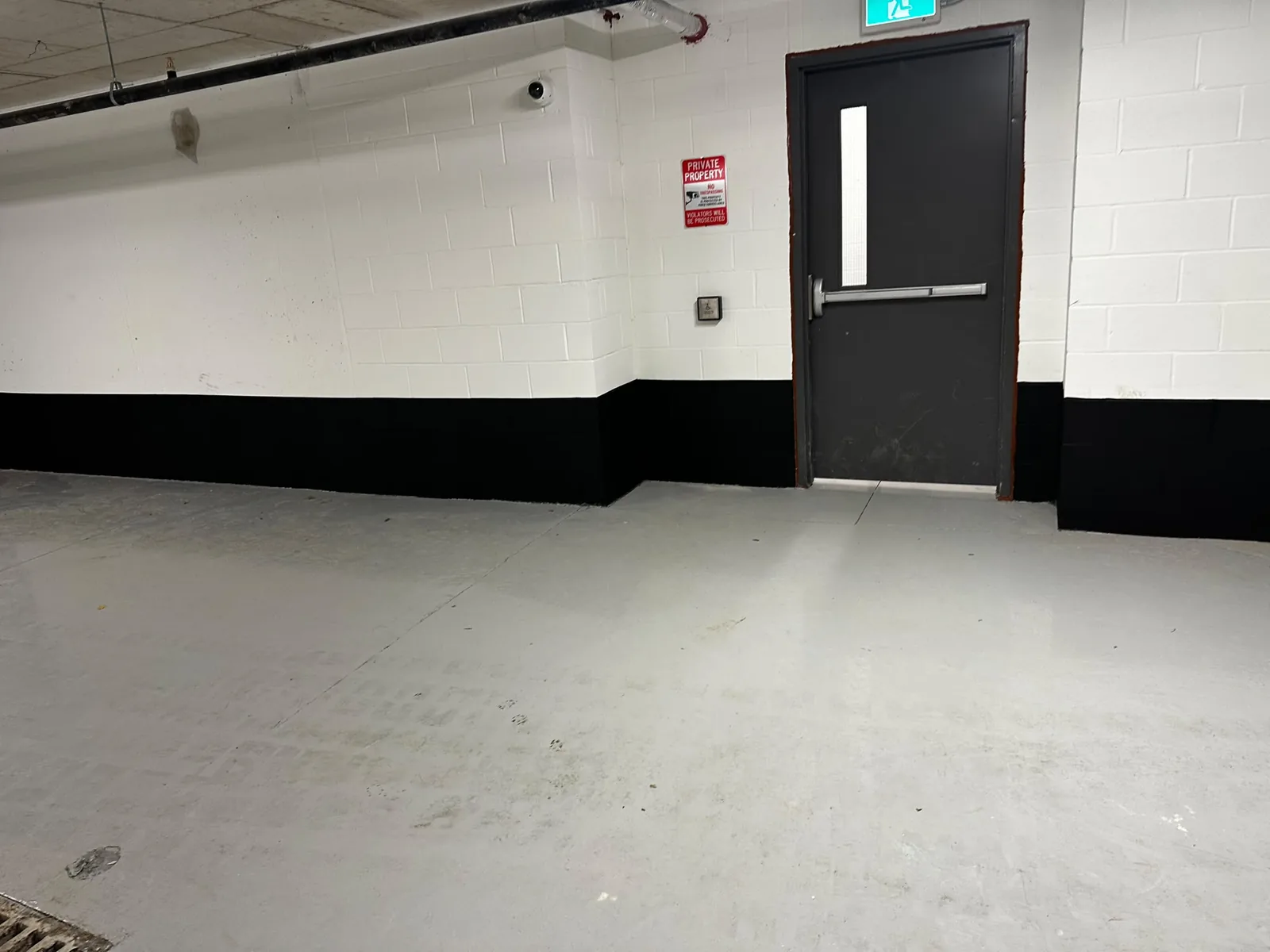 Commercial wall in Cambridge after painting with a clean black lower section and white upper section