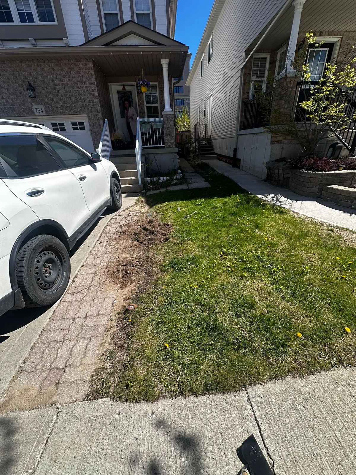 Waterloo front yard before landscaping with patchy grass beside the driveway and walkway
