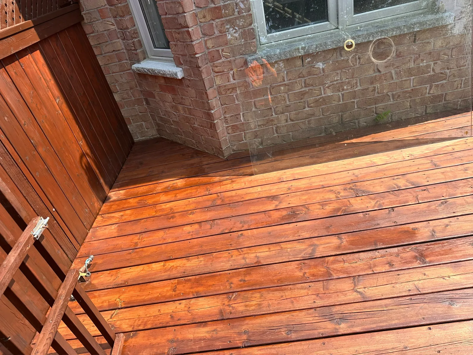 Wood deck during the repair and painting process with the surface freshly refinished