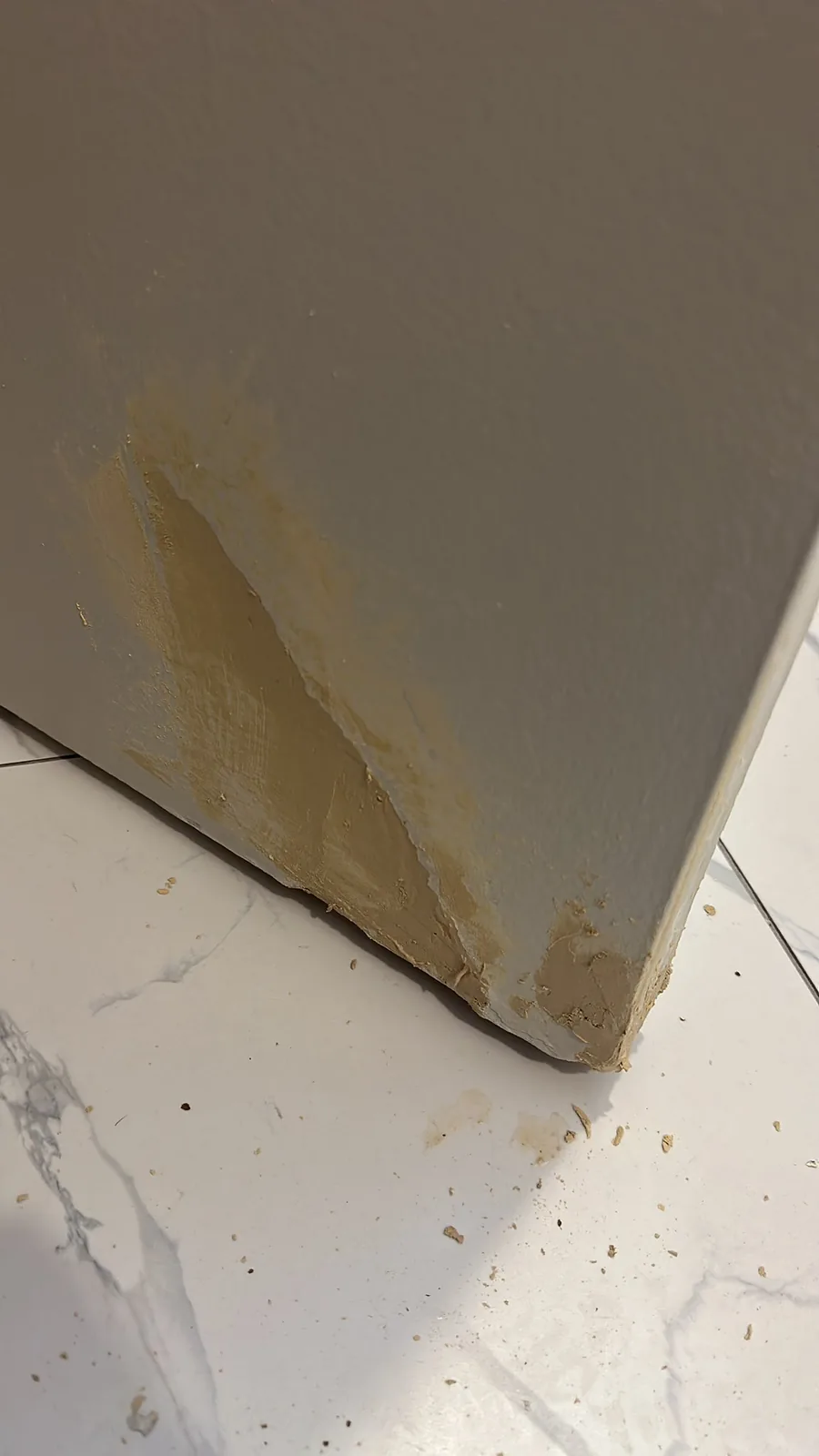 Lower corner of an interior door being patched during a Kitchener repair job